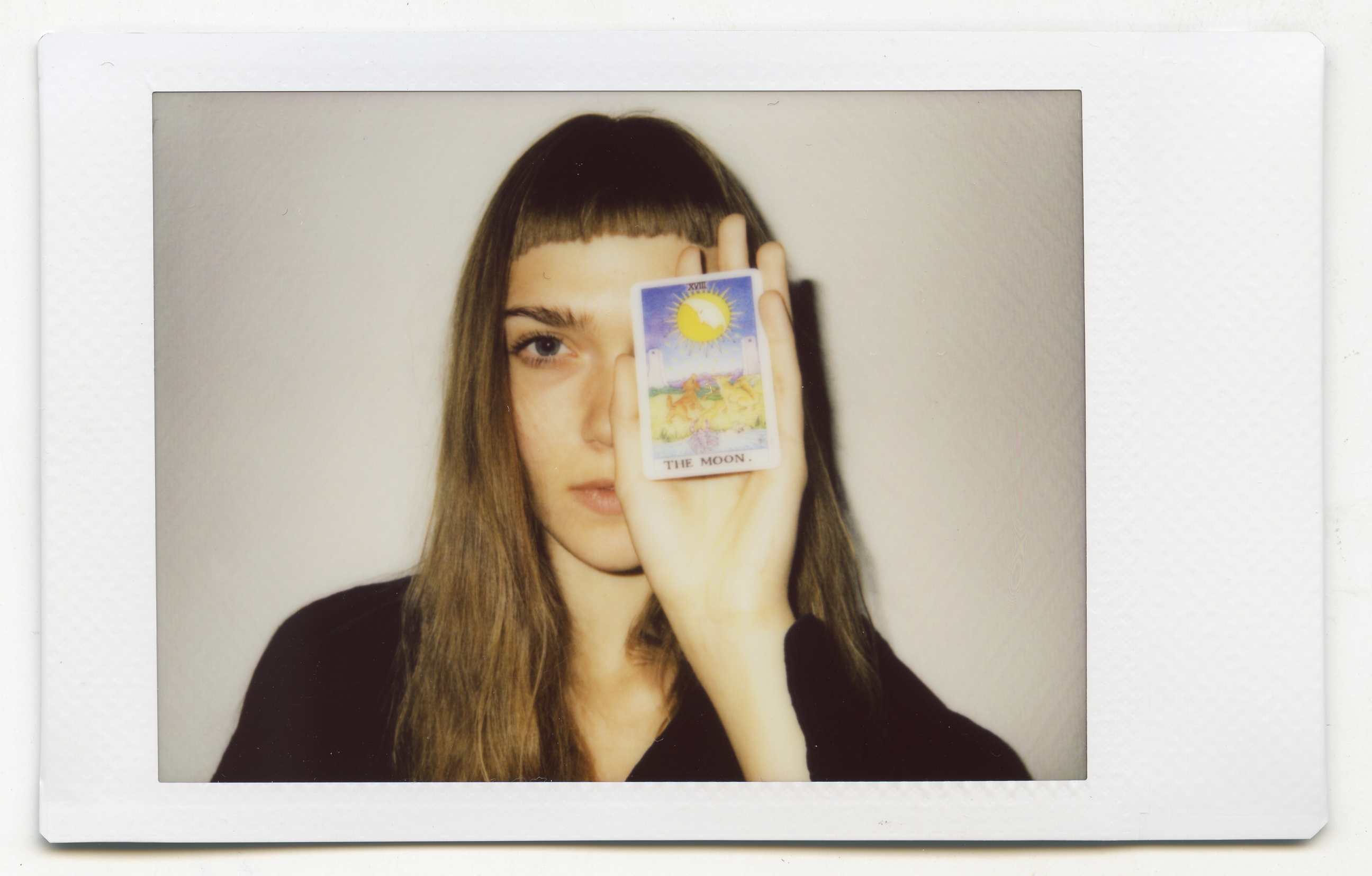 Tanya Fishmann, Liberation, 2021, performance documentation 2 of 2, participant holding a Major Arcana Tarot card, analog portrait ritual for transforming personal memory