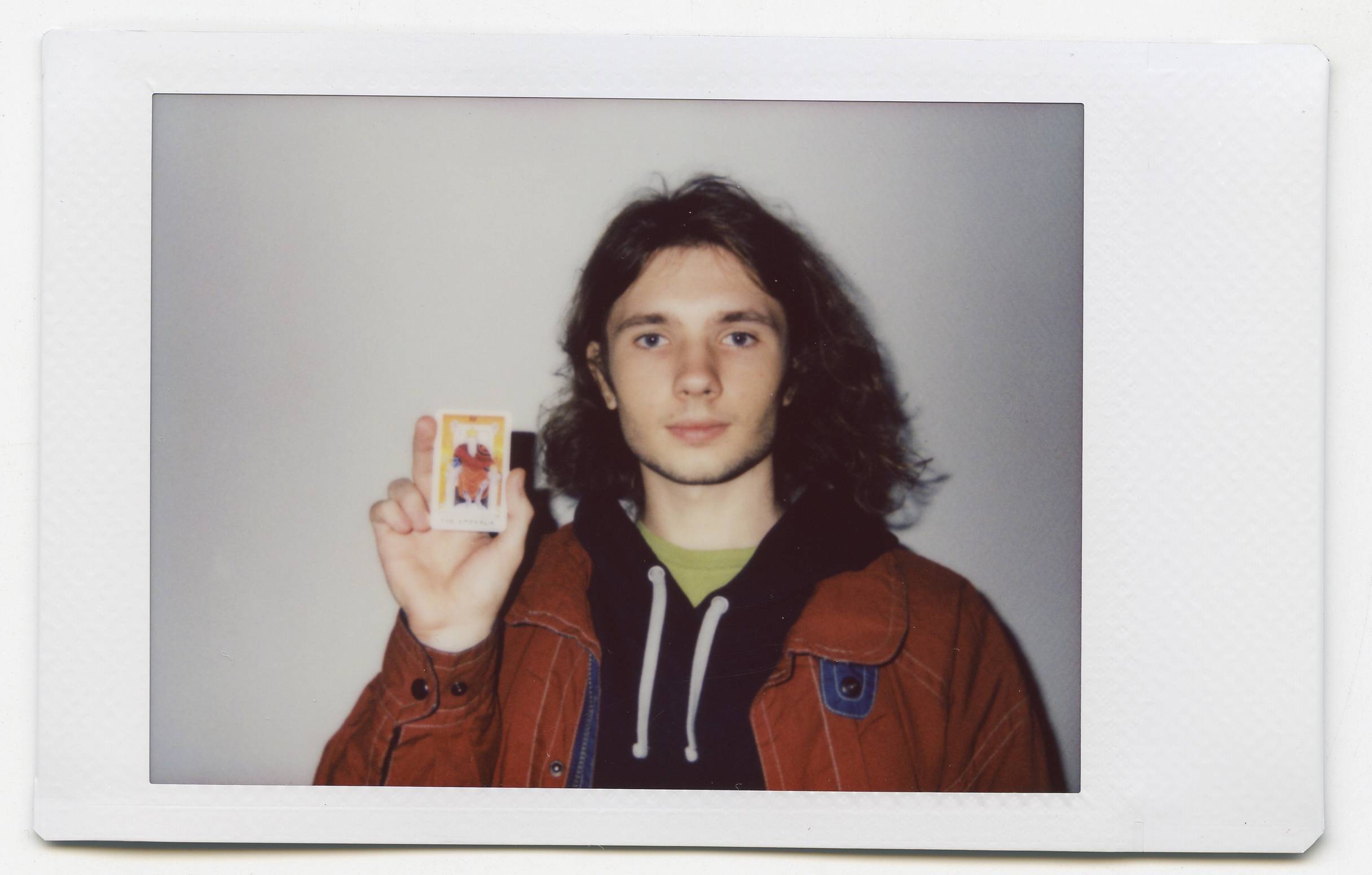 Tanya Fishmann, Liberation, 2021, instant analog portrait of a participant holding their Major Arcana Tarot card after the performance encounter